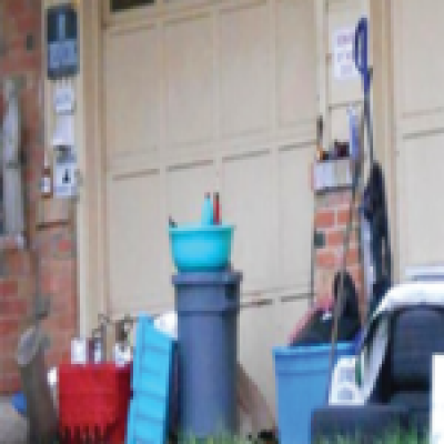 Possessions stored outside of a home in front of the garage